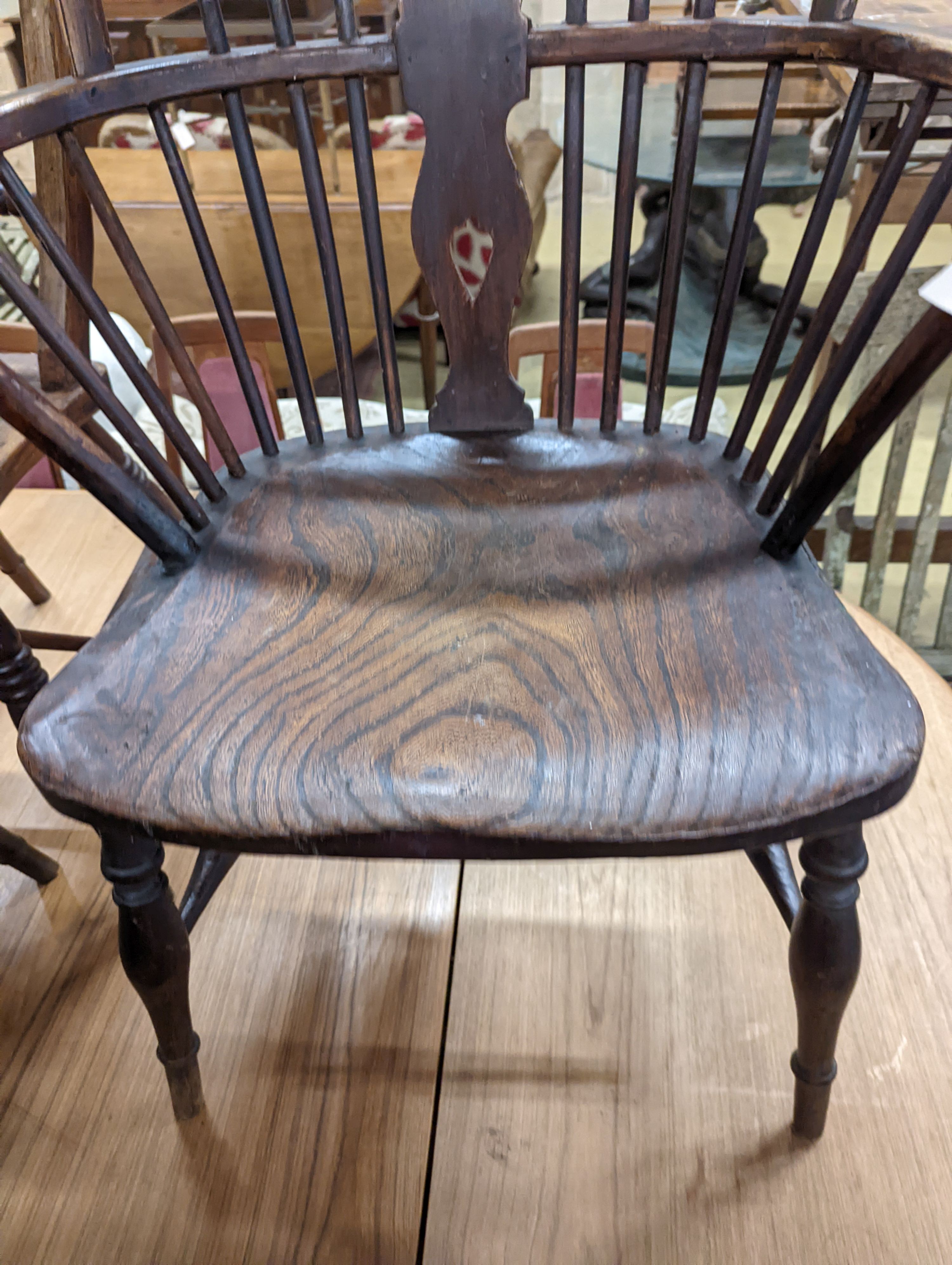 A mid 19th century Windsor ash and elm comb and wheelback armchair. H-104cm.